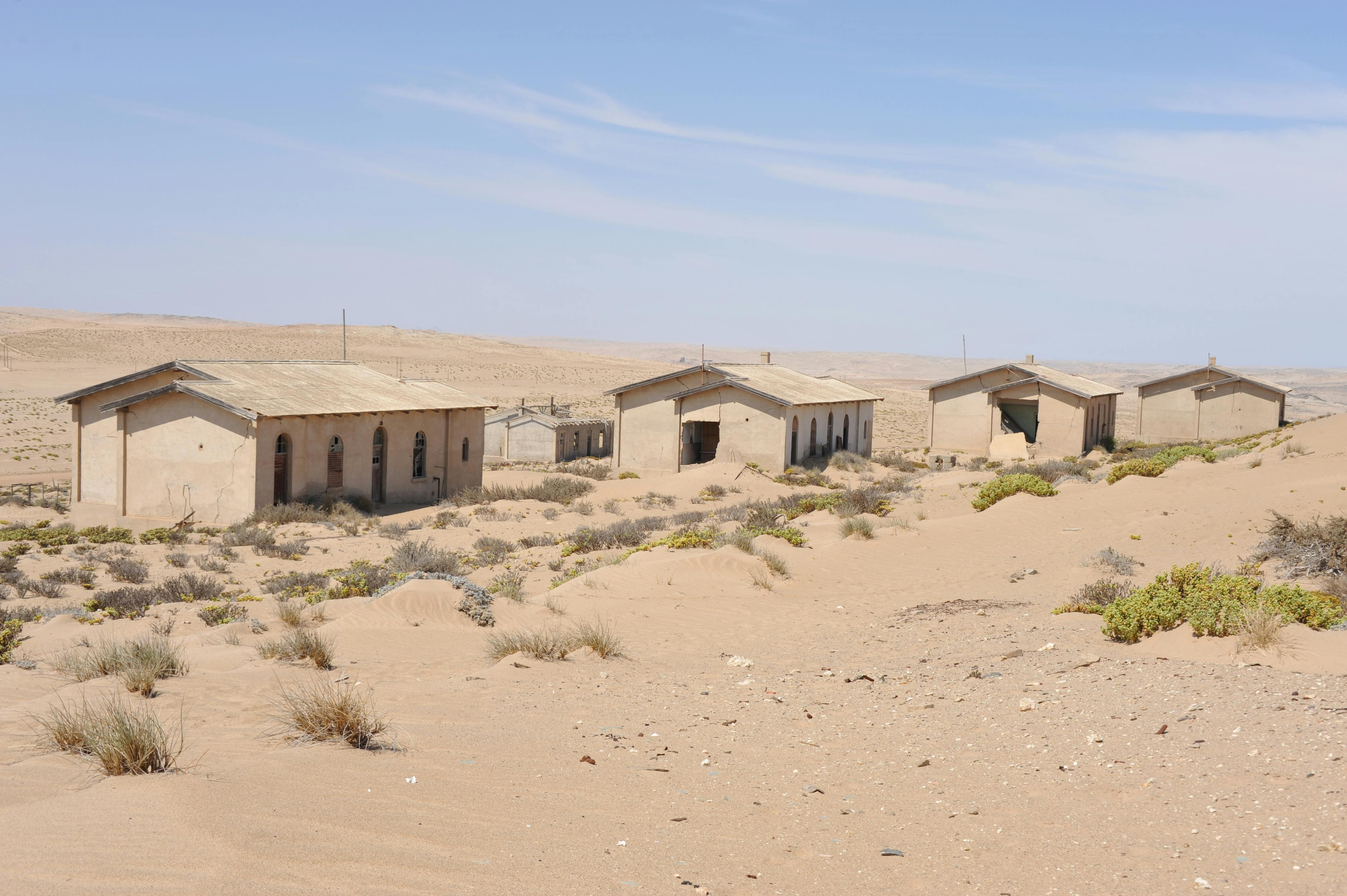View of abandoned buildings in the desert at Kolmanskop, Namibia, once a thriving village
