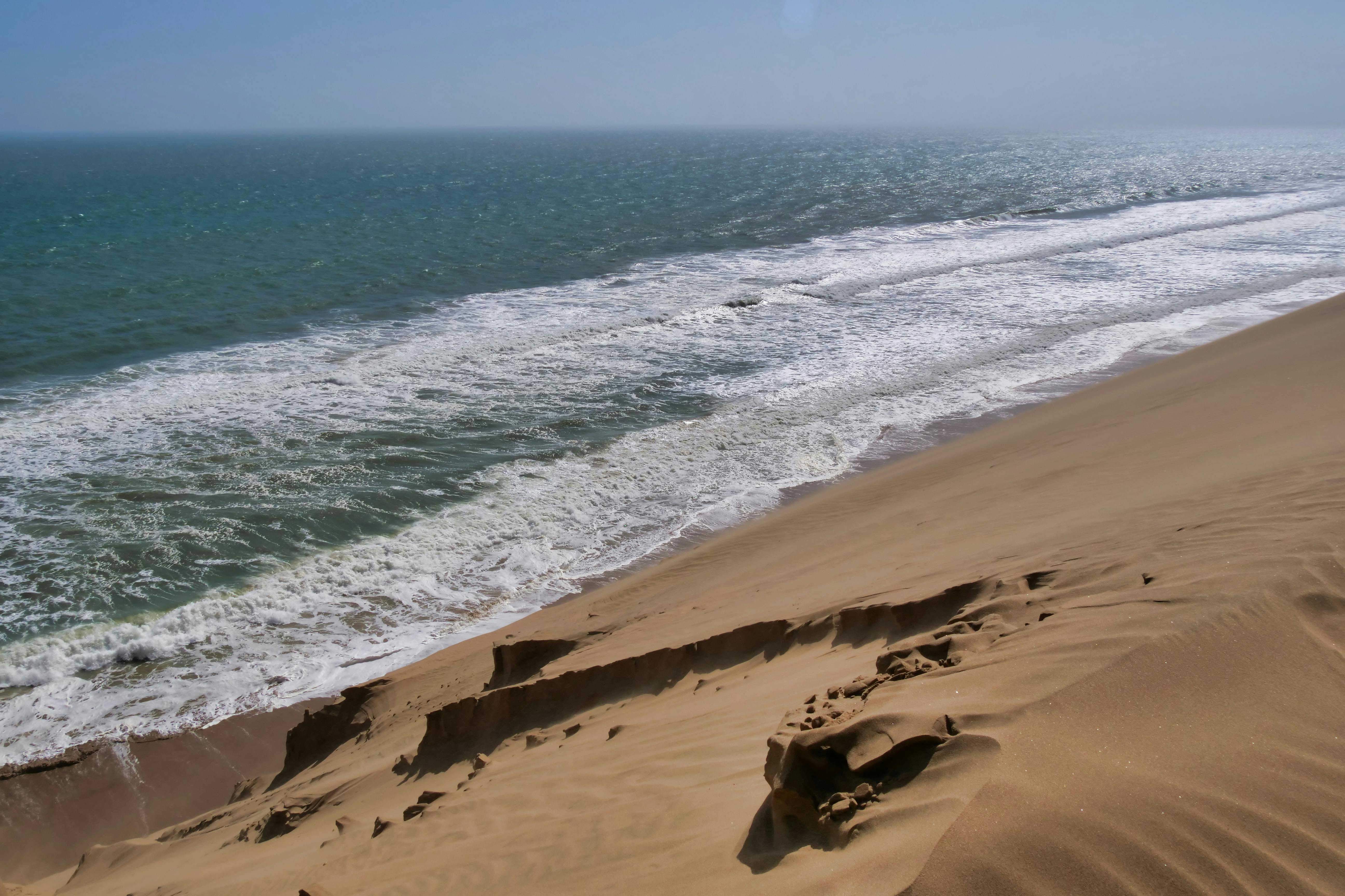 Peaceful view of coastal sand dunes with ocean waves
