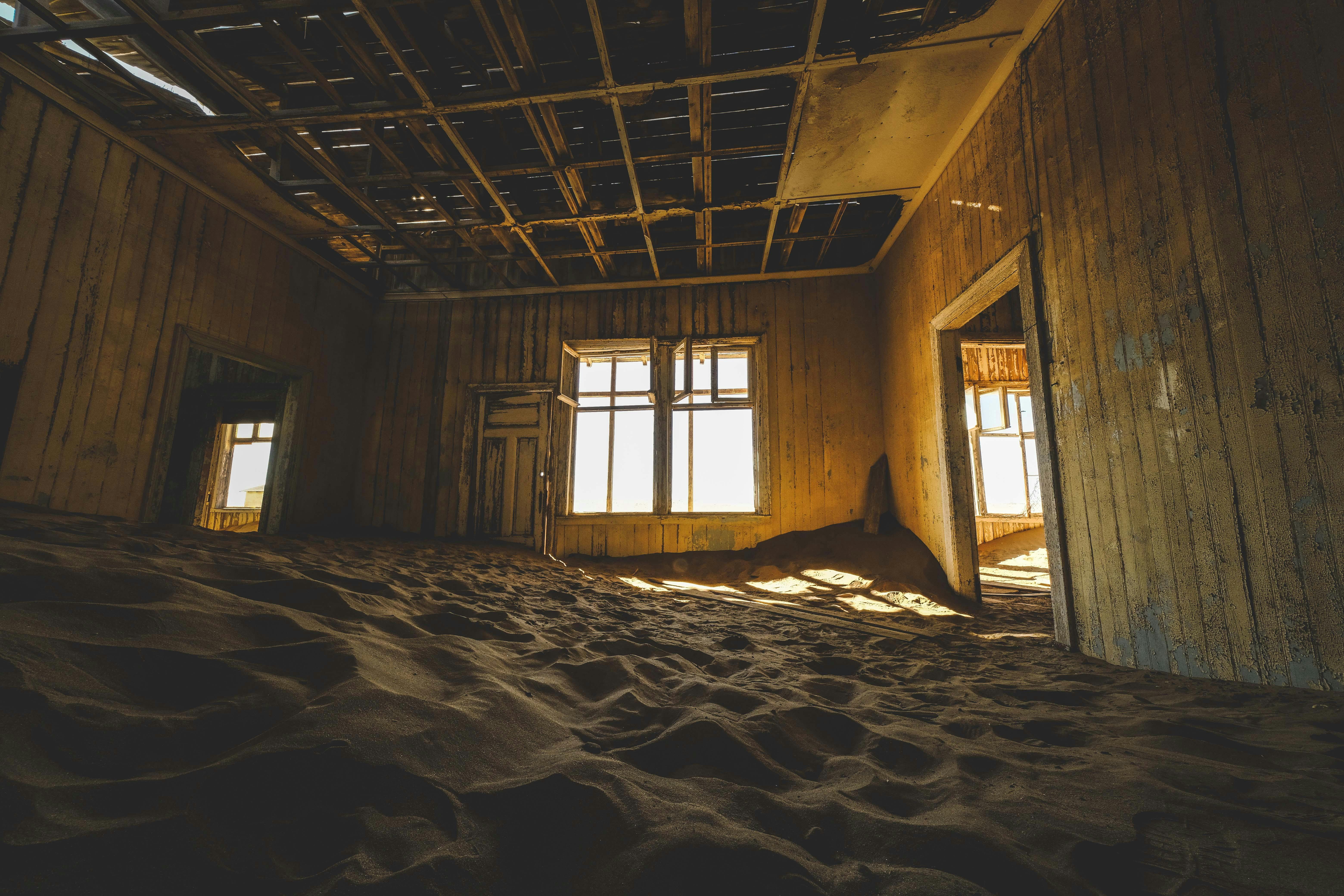 Abandoned building with sand-filled interior, showcasing decay and architectural beauty